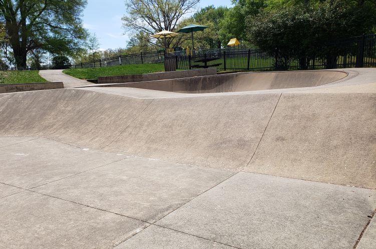 Greenbelt's skateboard park: curved concrete seen through iron bars